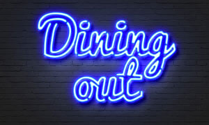 The words dining out in neon