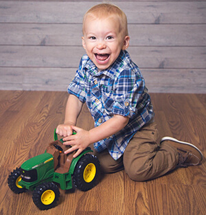 cooper playing with toy tractor