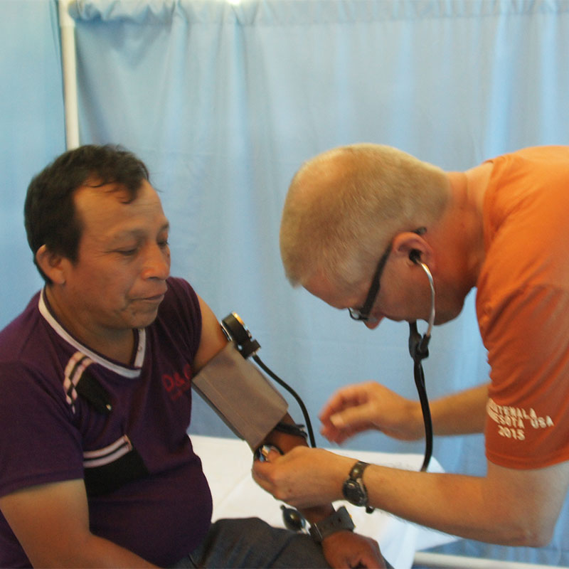 Dr. Haugen checks a patient’s blood pressure in a clinic in Guatemala.