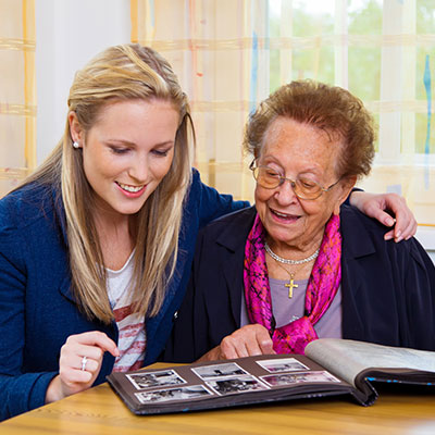 woman helping elderly woman