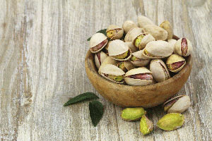 Bowl of pistachios on a table