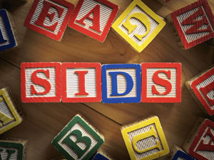 Wooden letter blocks spelling out "SIDS".