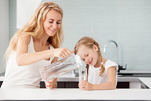 mother and daughter drinking water