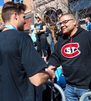 Bryan shaking hands with Dr. Martin-Chaffee after running a marathon