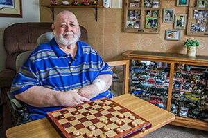 Jimmy Schultz, dialysis patient, sitting in a chair in his own home